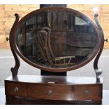 A 19th century mahogany dressing mirror, oval bevelled plate flanked by scrolling supports,