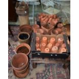 A crown top chimney pot; a quantity of terracotta plant pots,