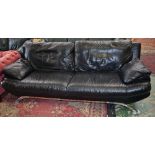 A contemporary black leather sofa,
