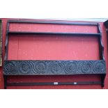 A carved oak wall hanging shelf/plate rack,