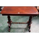 A mahogany library table, rounded rectangular oversailing top, turned supports and stretcher,