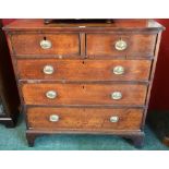 A George III oak chest of two short and three long graduated cockbeaded drawers,