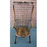 A 19th century elm wingback Windsor elbow chair, or unusual proportions, saddle seat,