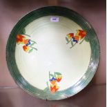 A Crown Ducal charger, orange, blue and yellow stylised flower heads on green ground,