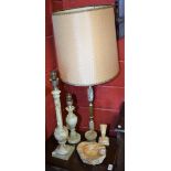 An onyx floor standing lamp; similar table lamps and candlestick; a carved stone bust,