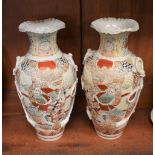 A pair of Japanese Satsuma baluster vases, decorated in the typical palette,