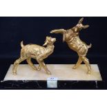 An Art Deco style study of two goats, one rearing, in gilt metal on a rectangular onyx base,