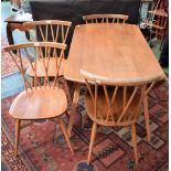 An Ercol light elm elliptical dropleaf dining table;