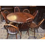 An Ercol elliptical drop leaf dining table,