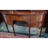 A George III mahogany sideboard, bow-fronted top above an arrangement of drawers, arched apron,