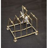 An electroplated five bar toast rack, in the manner of Christopher Dresser,