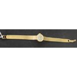 Longines - a retro 1970s lady's 9ct gold bracelet watch, silvered dial, block batons,