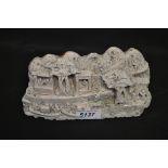 A Chinese carved soapstone fragment, with figures and huts beside a waterway with boats,