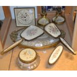 A brass filigree petit point dressing table set with clock