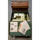 An early 20th century Vesta hand operated sewing machine, wooden cased; another,