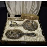 A silver three piece dressing table brush and hand mirror set, Birmingham 1967,