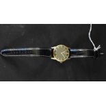 Omega - a 1950's wristwatch, gloss black dial, gilt block baton markers, minute track,