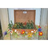 A set of twelve hand blown decorative glass flowers; a set of twelve jade type decorative trees;