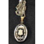 A 19th century tortoiseshell and silver pique work pendant