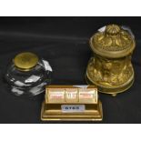 A 19th century ormulo inkwell, cast in relief with eagles, hinged cover, bun feet, c.