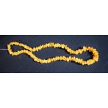 A copal amber river washed pebble free form bead necklace, 61cm long,