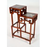 A Chinese hardwood two-tier vase stand, the tiers plateaux with inset dreamstone panels,