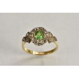 A green garnet and diamond cluster ring, central oval old cut vibrant green garnet approx 0.