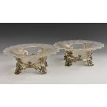 A pair of Victorian silver table centre comports, cast with flowers and foliage,