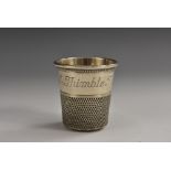 A silver novelty whisky tumbler, as an oversize sewing thimble, inscribed Only a Thimble Full,