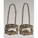 A pair of Victorian silver shaped rectangular wine labels, Brandy and Whiskey,