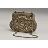 A Russian silver silver filigree bag shaped purse, centred by a vacant shield shaped cartouche,