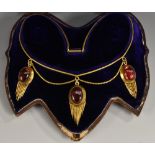A Victorian garnet oval cabouchon cut triple drop tassel necklace,