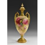 A Royal Worcester two handled pedestal ovoid vase, decorated with red and pink cabbage roses,