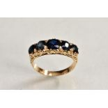 A sapphire line ring, central row of five graduating round cut blue sapphires,
