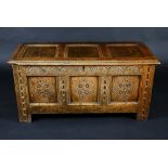A Charles II oak three panel blanket chest, hinge top, lunette carved frieze,