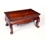 A Chinese padouk wood rectangular low tea table, panel top with shallow gallery,