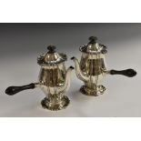 A pair of George V silver fluted baluster cafe au lait pots, hinged covers, shaped bases,