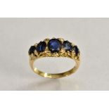 A sapphire and diamond line ring, inset with five graduated blue sapphires,