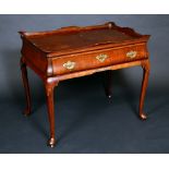 A 19th century Dutch mahogany bombe shaped silver table, shaped gallery above a long frieze drawer,