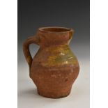 A post-Medieval green ware terracotta baluster ale jug,