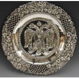 A Spanish silver shaped circular charger, the field chased with double-eagle and coat of arms,