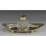 A George V silver and cut glass navette-shaped inkstand, faceted well with hinged cover,