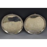 A pair of George III silver circular salvers, beaded borders, tapered feet, 20.