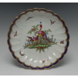 A Worcester fluted saucer shaped dish, by Dr Davis, painted with exotic birds in landscape,