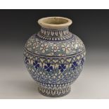 A Middle Eastern Iznik earthenware ovoid vase, decorated in the Islamic taste,