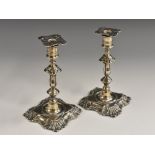 A pair of Victorian silver tapersticks, of George II design, detachable nozzles, knopped stems,