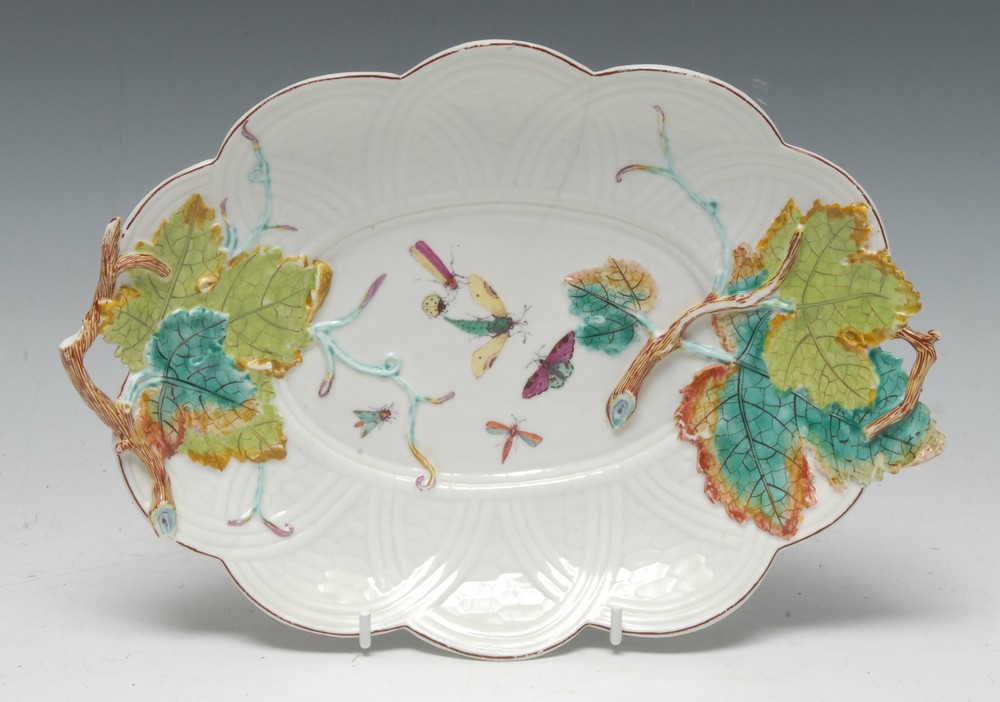 A Chelsea leaf and basket weave moulded twig handled dish, painted with moths, in relief with vine,