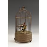 An automaton, as a pair of songbirds in a brass cage, clockwork mechanism, ring finial,