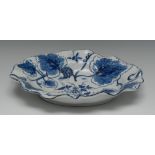 A Bow shaped circular dish, decorated in blue and white with grapes and vine, 26cm wide, c.
