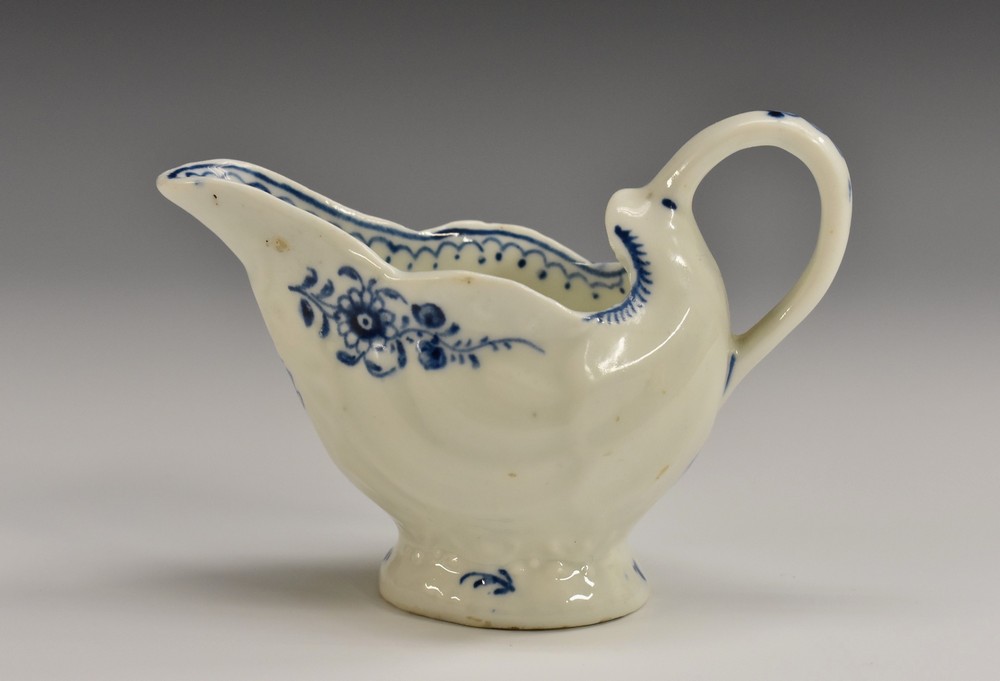 A Lowestoft Daisy pattern dolphin ewer, painted in underglaze blue with floral sprays,